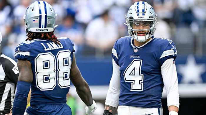 Dak Prescott and CeeDee Lamb on the field between plays